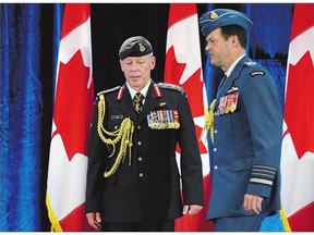 Outgoing Chief of Defence Staff Gen. Tom Lawson, right, and new Chief of Defence Staff Gen. Jonathan Vance participate in a change of command ceremony in Ottawa on Friday. Vance warned military leaders to treat those in uniform properly or risk losing their best personnel.