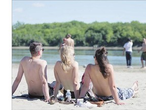 People participate at the "Free the Nipple" protest at the Spadina sandbar on Sunday.