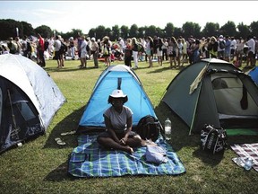 People queue up for tickets while others camp out at the All England Lawn Tennis and Croquet Club in London on July 2.