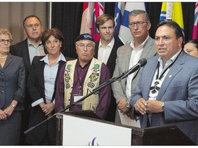 Perry Bellegarde, national chief of the Assembly of First Nations, addresses a news conference as Ontario Premier Kathleen Wynne, left, Yukon Premier Darrell Pasloski, B.C. Premier Christy Clark, Clement Chartier, president of Canada's Metis National Council, N.B. Premier Brain Gallant and Newfoundland and Labrador Premier Paul Davis, right, look on at a meeting of Canadian premiers and national aboriginal leaders on Wednesday.