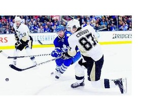 Pittsburgh Penguins' Sidney Crosby, right, could be setting up former Leafs forward Phil Kessel, who was traded to the Penguins in a six-player deal on Wednesday.