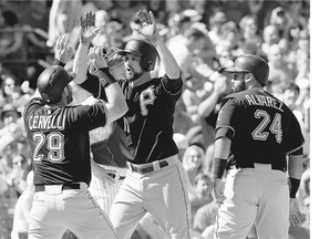 Pittsburgh Pirates' Jordy Mercer, centre, celebrates with Francisco Cervelli, left, and Pedro Alvarez after hitting a three-run home run Saturday against the Chicago Cubs - both teams, along with St. Louis, have clinched playoff berths in the National League's Central division.