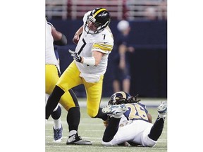 Pittsburgh Steelers quarterback Ben Roethlisberger is injured as he is hit by St. Louis Rams strong safety Mark Barron during the third quarter Sunday. Michael Vick will take over for the Steelers at quarterback.