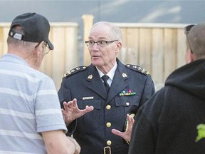 Police Chief Clive Weighill visits with members of Str8-Up - including Father Andre Poilievre and Shane Taysup - who attended the public meeting on policing in the city at the farmers market on Tuesday.