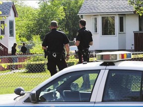 Police investigate a double shooting at a small housing complex in the 300 block of Avenue R South Monday.