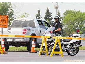 A police motorcycle officer at a construction zone. Charges have been laid in two serious orange-zone crashes earlier this summer, one of which took three young lives.