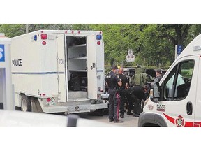 A police tactical team, emergency crews and a bomb unit investigate an explosion at a law rm in Winnipeg last week.