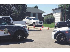 Police vehicles at the scene of an accident that killed a 16-month-old boy in Confederation Park Friday. Neighbours said the boy was hit by a truck backing out of a driveway.