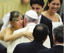 Pope Francis is greeted by newlyweds during a general audience at the Vatican on Wednesday. Divorced people who have remarried 'are still part of the Church', he insists.