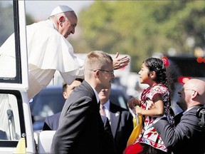 Pope Francis reaches to give a blessing to Sophie Cruz, 5, from Los Angeles, during a parade in Washington Wednesday. Although the moment seemed spontaneous, immigration rights groups hand-picked Cruz to deliver a message to the Pope.