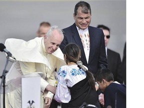 Pope Francis is welcomed by children upon his arrival in Quito, Ecuador, on Sunday, the first day of his eight-day tour of Ecuador, Bolivia and Paraguay.