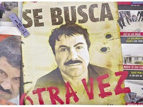 A poster with the face of Mexican drug lord Joaquin 'El Chapo' Guzman reads 'Wanted, Again.' Internal DEA documents show agents received information in March 2014 that Guzman's associates were considering ways to free the drug lord.