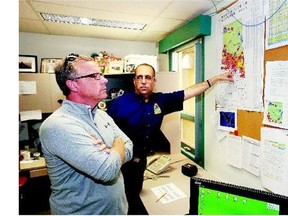 Premier Brad Wall, left, is shown a fire map by Steve Roberts, executive director wildfire management with the Ministry of the Environment during a tour of the Prince Albert Wildfire Management base Tuesday.