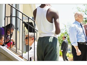 U.S. President Barack Obama, third from left, greets residents in the Treme neighbourhood in New Orleans on Thursday.