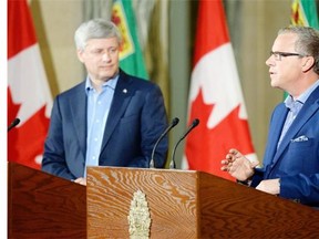 Prime Minister Stephen Harper, left, and Saskatchewan Premier Brad Wall hold a news conference at the Legislative Building in this file photo.