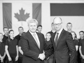 Prime Minister Stephen Harper, left, and Ukrainian Prime Minister Arseniy Yatsenyuk in June. Yatsenyuk heads to Ottawa Tuesday to meet again with Harper and is expected to sign a free trade deal with Canada.