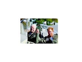 Prince Harry holds hands with Battle of Britain veteran Tom Neil in a Spitfire after a Battle of Britain Flypast Tuesday.
