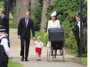 Prince William, his wife Kate, their son Prince George and daughter Princess Charlotte, in a stroller, arrive for Charlotte's christening at St. Mary Magdalene Church in Sandringham, England, on Sunday.