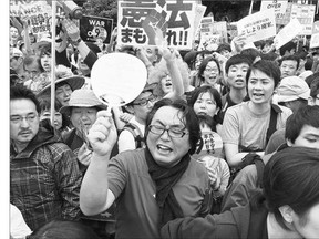 Protesters hold an antigovernment rally Sunday in Tokyo to protest Prime Minister Shinzo Abe's legislation to expand the remit of its armed forces.