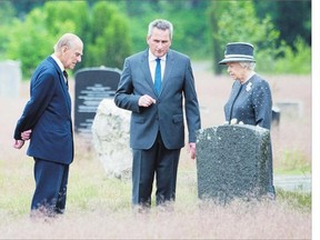 Queen Elizabeth and Prince Philip view Anne Frank's grave Friday during their visit to the concentration camp memorial at Bergen-Belsen in Lohheide, Germany.