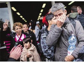A refugee cries as he arrives at the main station in Dortmund, western Germany, on Sunday.