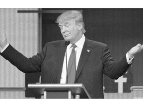 Republican presidential hopeful Donald Trump gestures during the start of the first Republican debate Thursday in Cleveland. It's a key test for Trump, who sits atop the polls but has been criticized by rival GOP contender Jeb Bush, the former governor of Florida, for being too negative and angry.