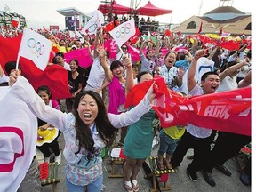 Residents in the ski resort region of Chongli, China, celebrate Friday's news that Beijing has been selected by the IOC to host the 2022 Winter Olympics.
