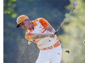 Rickie Fowler hits from the rough on the 13th hole on his way to winning the Deutsche Bank Championship Monday.