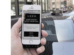 The ride-sharing app Uber is shown on a smartphone in Montreal in May. A ruling from a California labour board that Uber drivers are employees of the company and not self-employed contractors sets a precedent that could spell trouble for the ride-sharing service's Canadian operations.