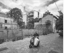 A man rides a motorbike past abandoned buildings in Athens on Friday. Greek and EU negotiators are so tired of each other, it gets harder every day to see any way to avoid a 'Grexit,' as Athens' ejection from the eurozone has been dubbed, writes Matthew Fisher.