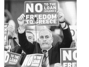 Far-right European Union parliament members hold posters ahead of Greek Prime Minister Alexis Tsipras's speech in Strasbourg on Wednesday. The notion that Greece has been brought to its present humiliation by the cruelty of its lenders is near-universal and reflects a simplistic view of the economy, writes Andrew Coyne.