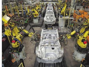 Robotic arms assemble and weld the body shell of a car at Nissan's plant in Sunderland, England.