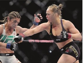 Ronda Rousey, right, fights Brazil's Bethe Correia during their bantamweight title fight at UFC 190, early Sunday.