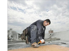 A roofer works in Los Angeles on Tuesday. Homeowners are bracing for possible downpours after four dry years.