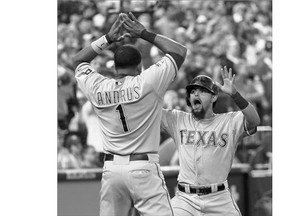 Rougned Odor of the Texas Rangers, right, celebrates scoring the winning run against the Blue Jays Friday in the 14th inning with Elvis Andrus. It gave Texas a 2-0 lead as they head home for Games 3 and 4 of the ALDS.