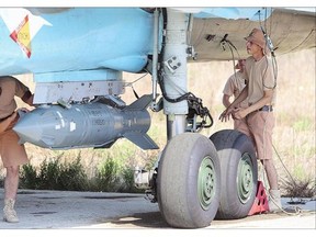 Russian air force technicians check a Su-34 fighter bomber at the Hmeimim airbase in the Syrian province of Latakia.