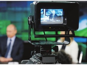 Russian President Vladimir Putin is shown on the screen of a camera viewfinder at the headquarters of Russia Today television channel in Moscow. Major brands Larry in the export division of Russian media include RT, the RIA Novosti news agency and its English-language arm Sputnik, and the Voice of Russia radio station.