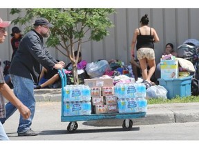 The Salvation Army delivers goods to the evacuee centre at the Henk Ruys Soccer Centre during a press conference there with Brad Wall on Thursday.