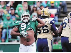 Saskatchewan Roughriders' Andre Monroe celebrates sacking Winnipeg Blue Bombers quarterback Brian Brohm during CFL action in Regina on Sunday.