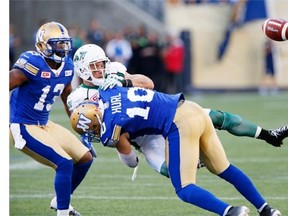 Saskatchewan Roughriders' Rob Bagg (6) drops the ball as he is hit by Winnipeg Blue Bombers' Samuel Hurl (10) during the first half of CFL action in Winnipeg Saturday, September 12, 2015. THE CANADIAN PRESS/John Woods