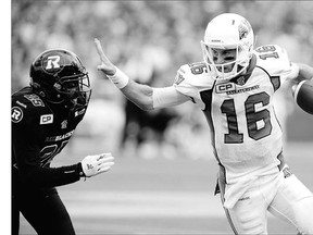 Saskatchewan Roughriders' Brett Smith, right, keeps the ball away from Ottawa Redblacks' Brandyn Thompson during first-half CFL action in Ottawa last Sunday.