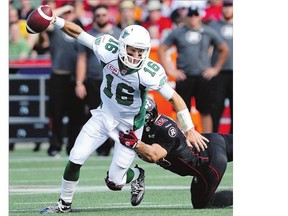 Saskatchewan Roughriders' Brett Smith tries to evade Ottawa Redblacks' Justin Capicciotti during first half CFL action in Ottawa on Sunday. The Riders lost for the ninth time this year.