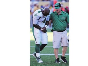 Saskatchewan Roughriders' Darian Durant leaves the field after getting hurt during a play against the Winnipeg Blue Bombers in Winnipeg on Sept. 7, 2014.