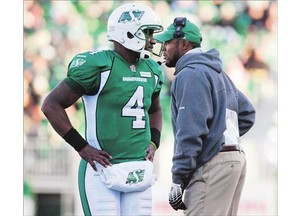 Saskatchewan Roughriders quarterback Darian Durant stands on the sidelines with former head coach Corey Chamblin in a 2013 game.