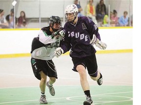 Saskatchewan Swat's Anthony Hallborg, left, puts pressure on St. Albert Crude's Owen Feist in Rocky Mountain Lacrosse action on Sunday. The Swat defeated the Crude 10-7.