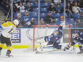 Saskatoon Blades' goalie Nik Amundrud stretches to stop a shot from Brandon Wheat Kings centre Stelio Mattheos during the second period of WHL action Saturday. The Wheat Kings won 4-1.