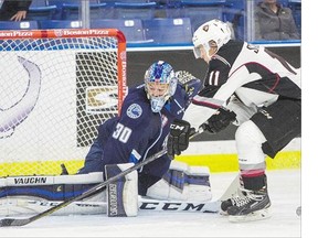 Saskatoon Blades goalie Brock Hamm makes a pad save against Vancouver Giants left wing Jakob Stukel during the second period of WHL action on Sunday. See if the Blades won their third straight overtime game on Page C1.