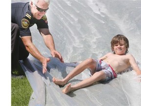 The Saskatoon Fire Department set up a slip and slide in John Lake Park on Tuesday where around 200 children showed up to take part in the fun.