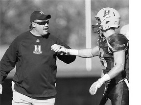 The Saskatoon Hilltops' head coach Tom Sargeant, left, with Derek Sadownick in October 2014, says the annual pre-season game against alumni is a great learning experience for young players.