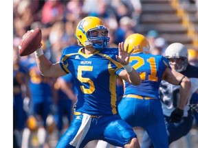 Saskatoon Hilltops quarterback Jared Andreychuk looks to throw a pass against the Regina Thunder at Saskatoon Minor Football Field in Saskatoon, SK. on Saturday, September 6, 2014.